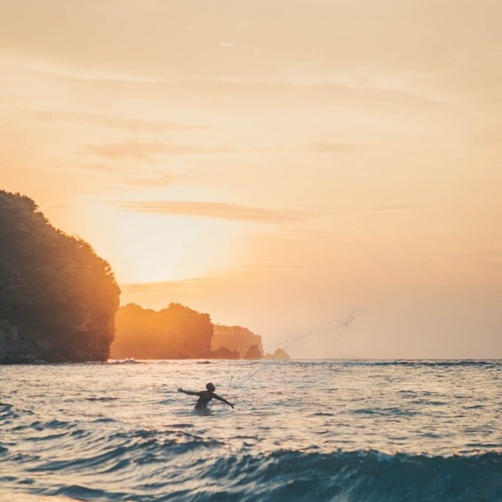 Casting a fishing net in the ocean.